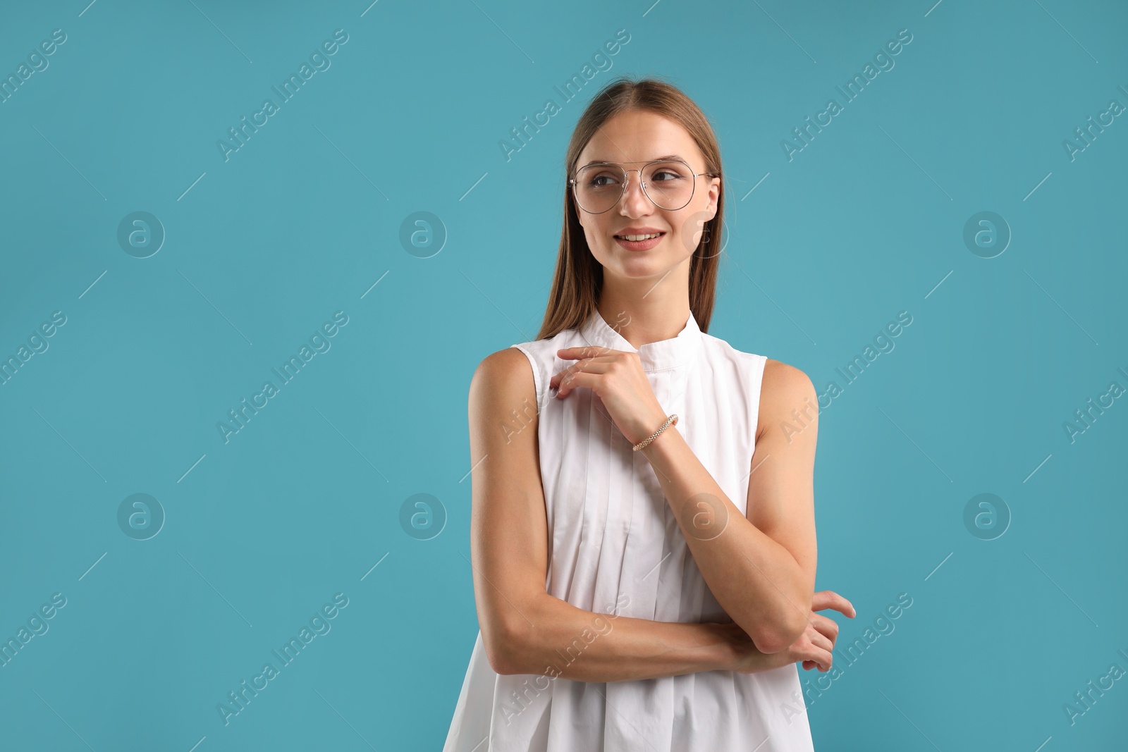 Photo of Portrait of beautiful woman on light blue background. Space for text