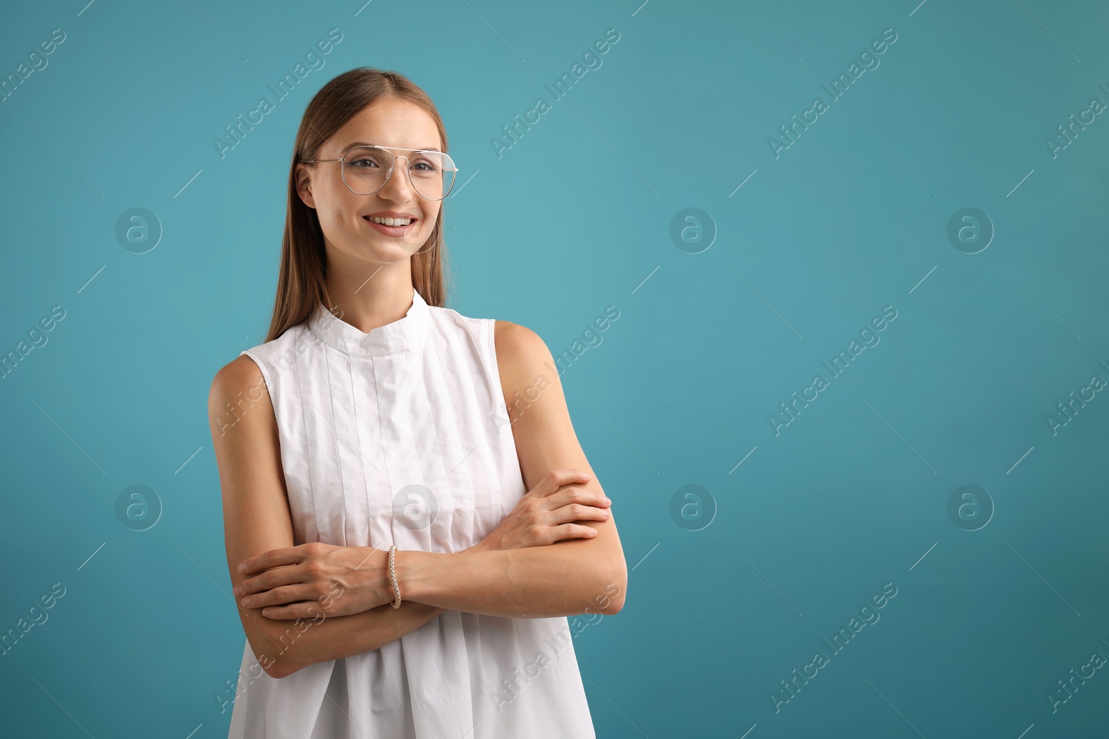Photo of Portrait of beautiful woman on light blue background. Space for text