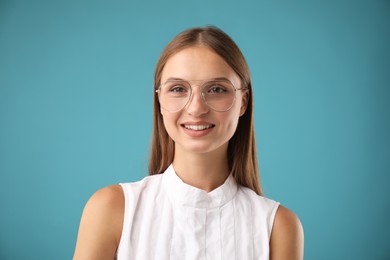 Photo of Portrait of beautiful woman on light blue background