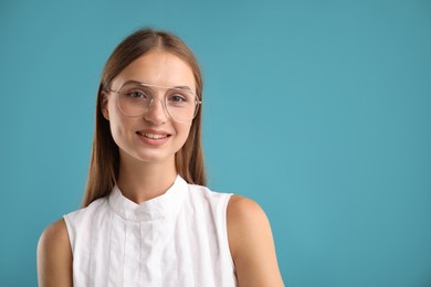 Photo of Portrait of beautiful woman on light blue background. Space for text