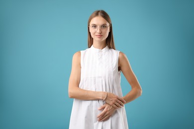 Photo of Portrait of beautiful woman on light blue background