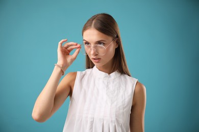 Photo of Portrait of beautiful woman on light blue background