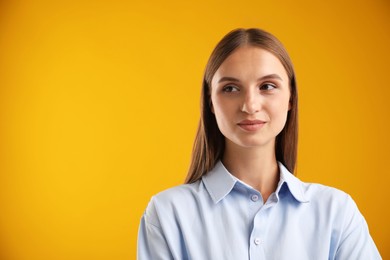 Photo of Portrait of beautiful woman on yellow background. Space for text