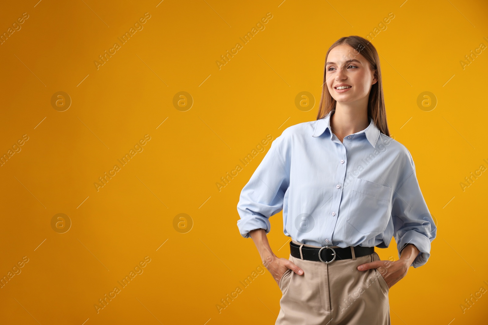 Photo of Portrait of beautiful woman on yellow background. Space for text