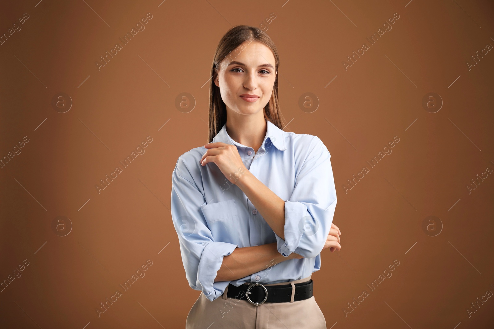 Photo of Portrait of beautiful woman on brown background