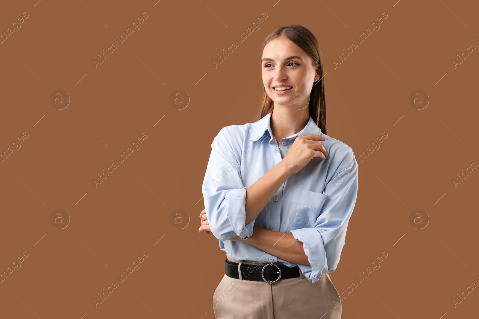 Photo of Portrait of beautiful woman on brown background. Space for text