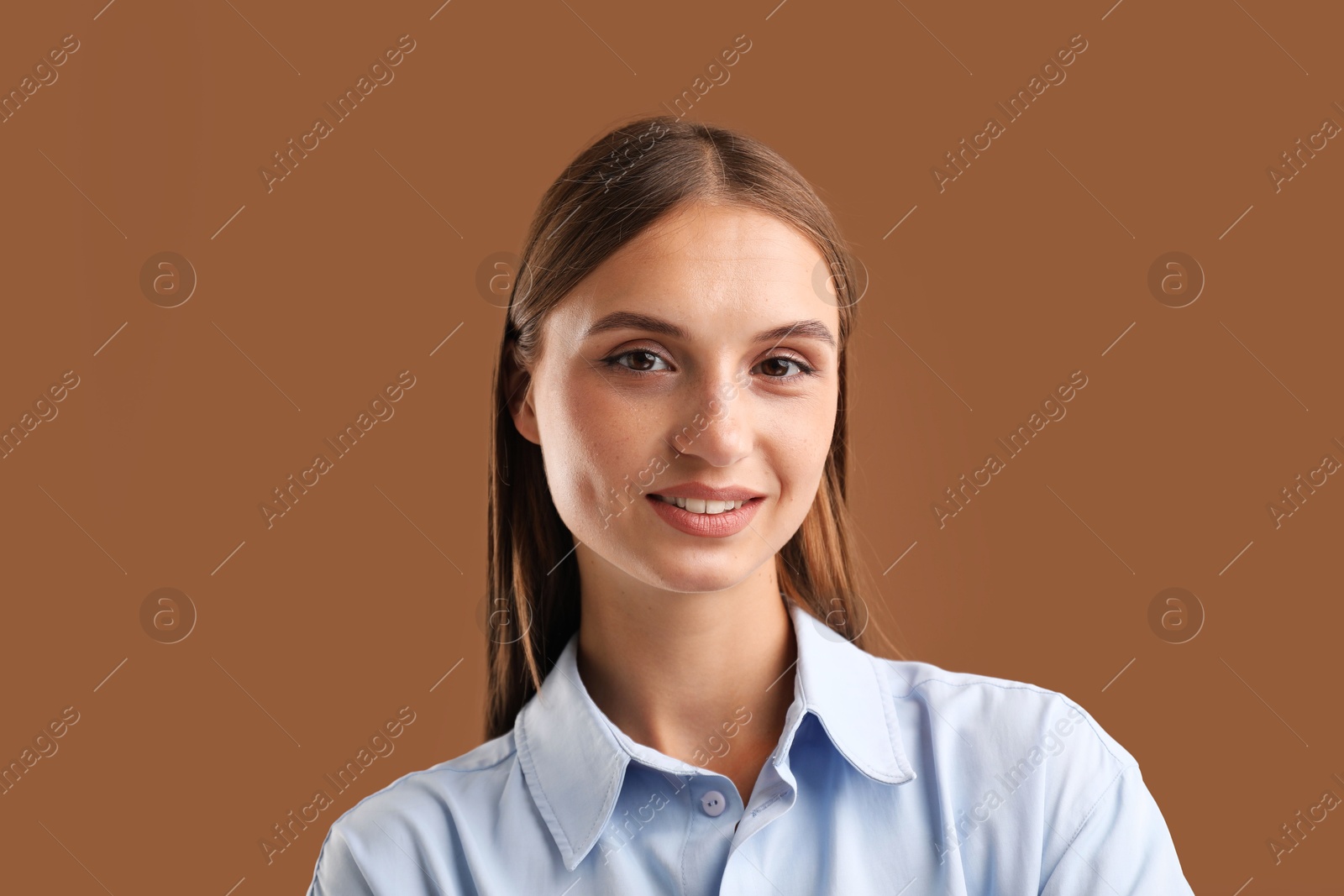 Photo of Portrait of beautiful woman on brown background