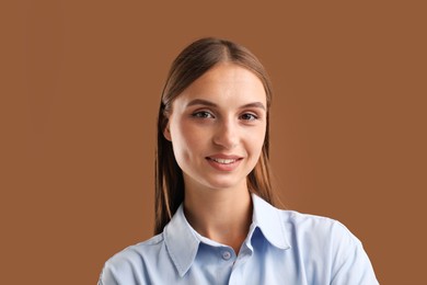 Photo of Portrait of beautiful woman on brown background