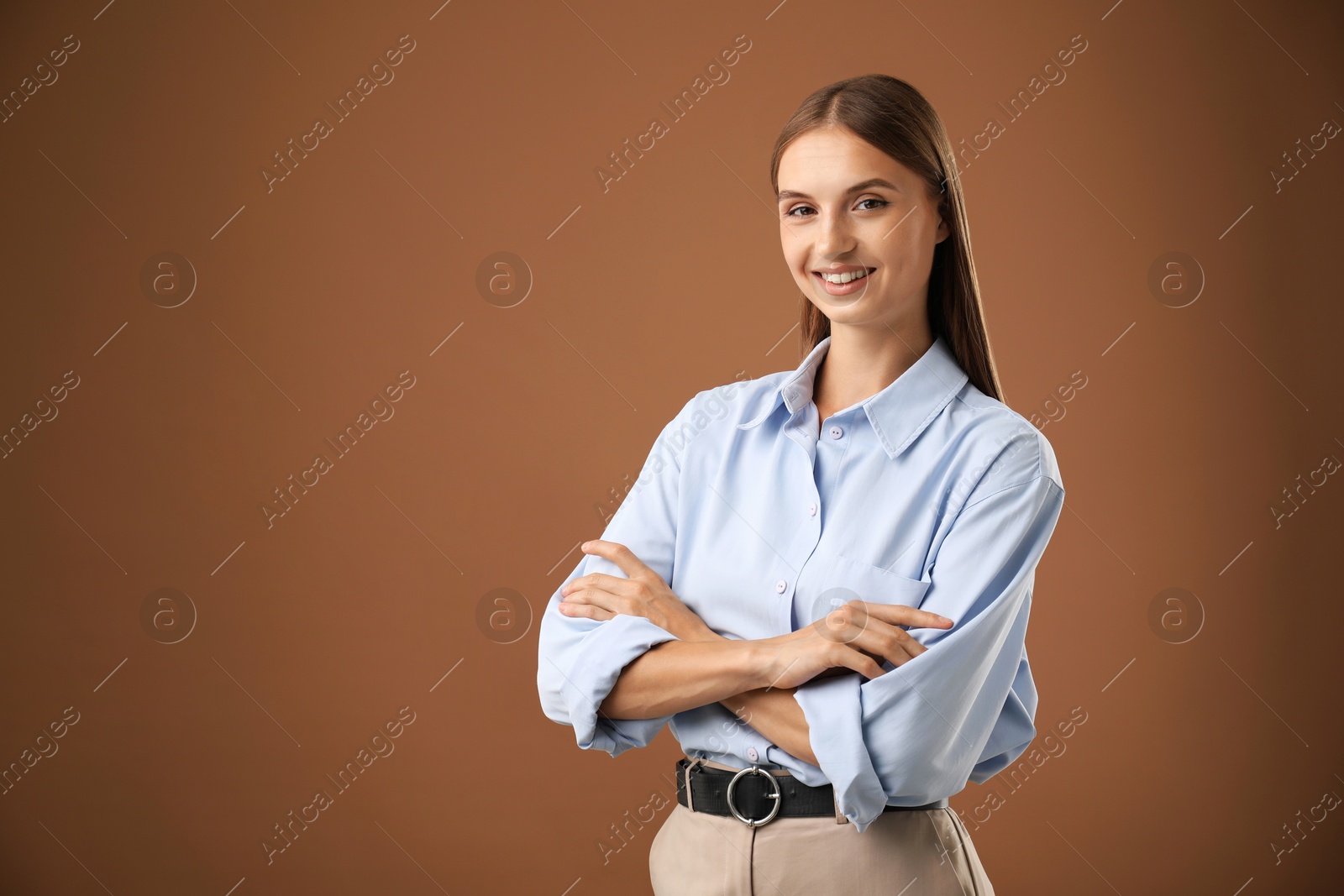 Photo of Portrait of beautiful woman on brown background. Space for text