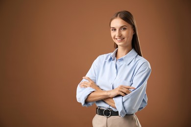 Photo of Portrait of beautiful woman on brown background. Space for text