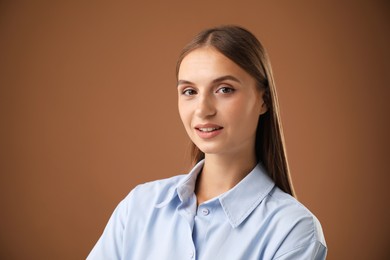 Photo of Portrait of beautiful woman on brown background