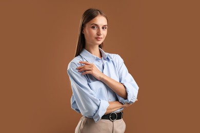 Photo of Portrait of beautiful woman on brown background