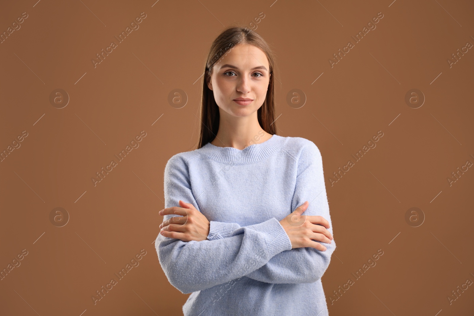 Photo of Portrait of beautiful woman on brown background