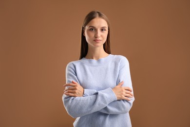 Photo of Portrait of beautiful woman on brown background