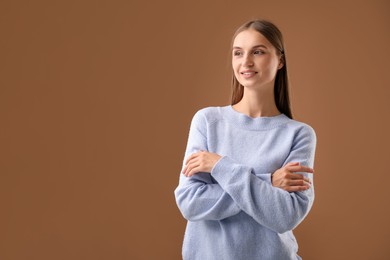 Photo of Portrait of beautiful woman on brown background. Space for text