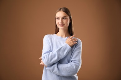 Photo of Portrait of beautiful woman on brown background