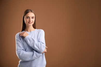 Photo of Portrait of beautiful woman on brown background. Space for text