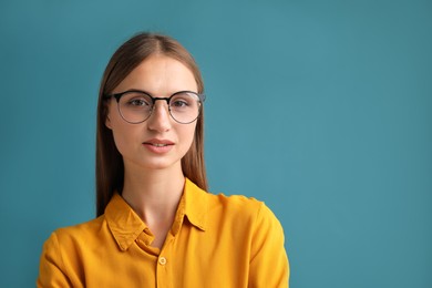 Photo of Portrait of confident woman on blue background. Space for text