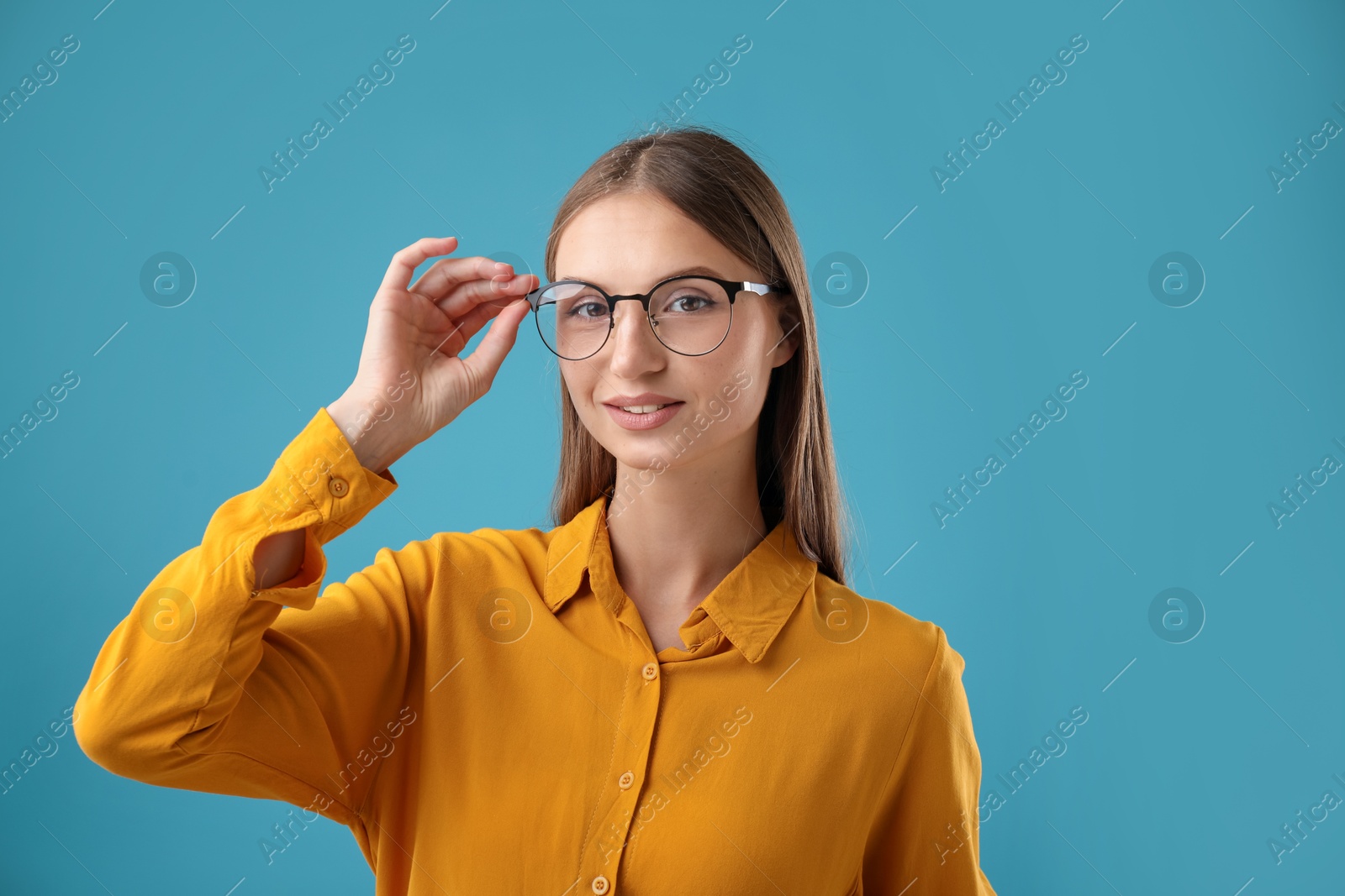 Photo of Portrait of confident woman on blue background