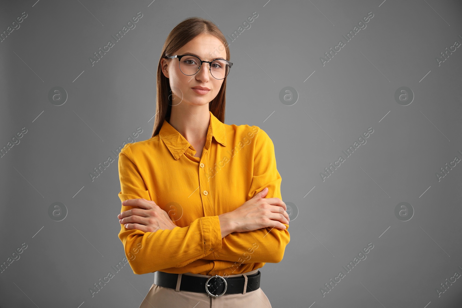 Photo of Portrait of confident woman on grey background. Space for text