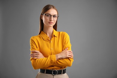 Photo of Portrait of confident woman on grey background. Space for text
