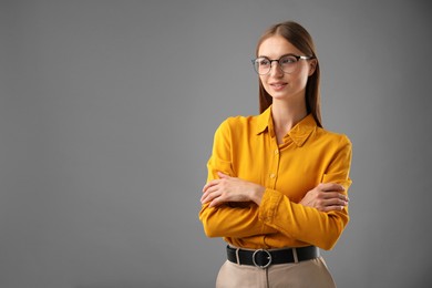 Photo of Portrait of confident woman on grey background. Space for text