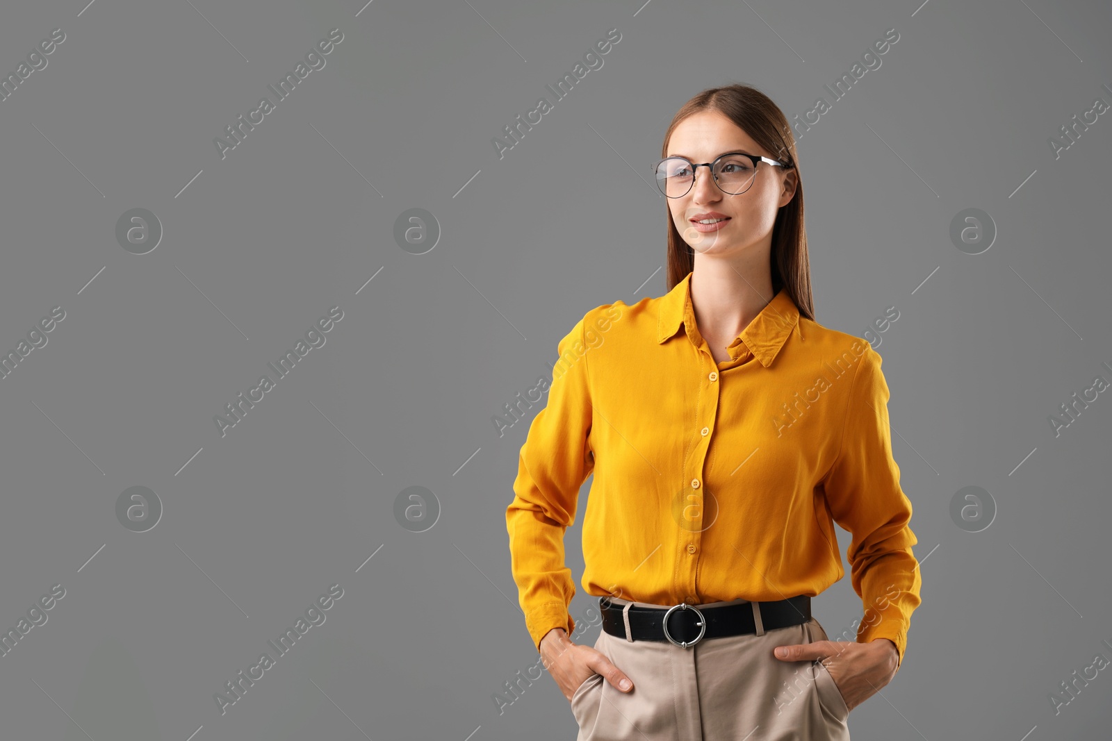 Photo of Portrait of confident woman on grey background. Space for text