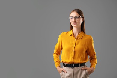 Photo of Portrait of confident woman on grey background. Space for text