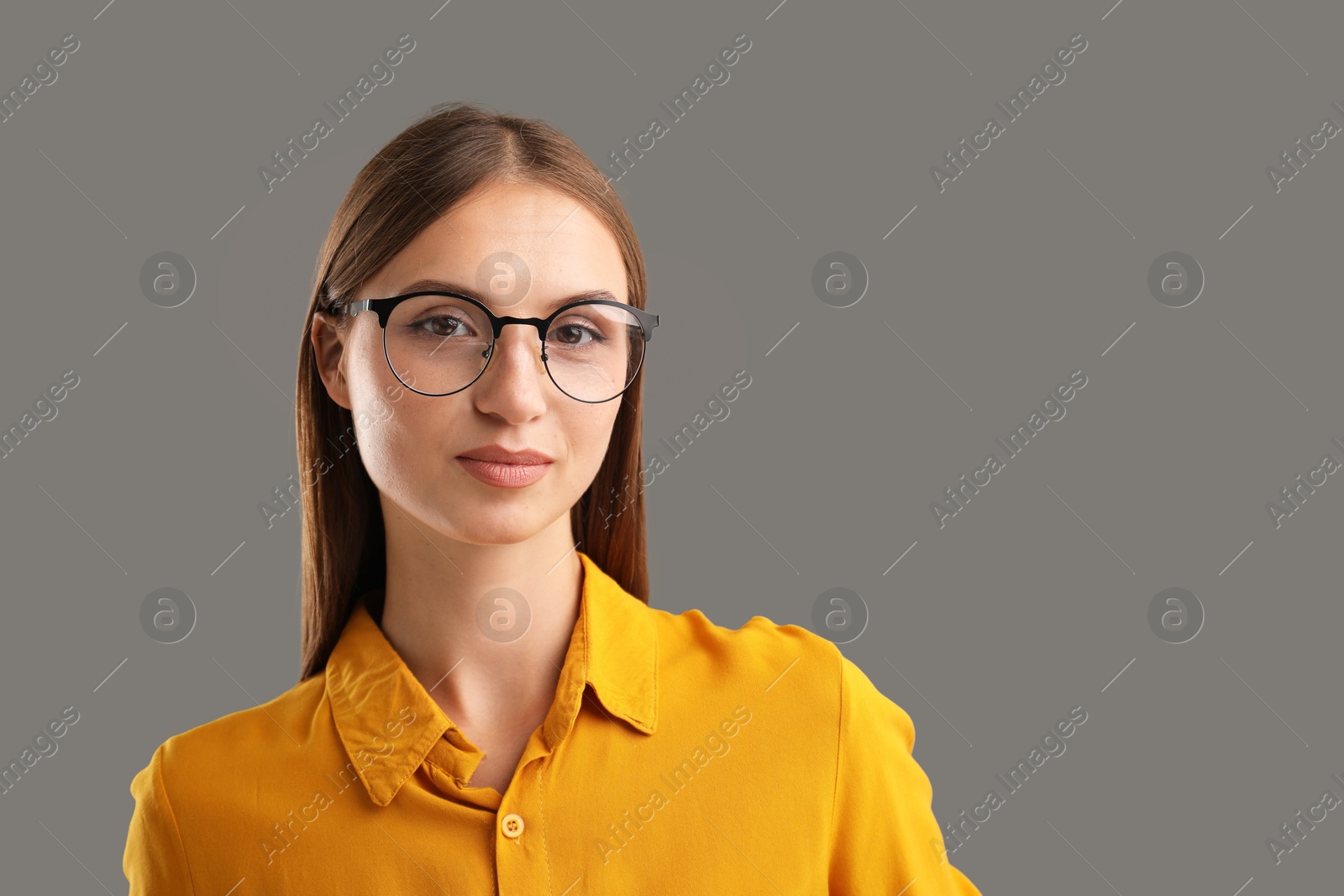 Photo of Portrait of confident woman on grey background. Space for text