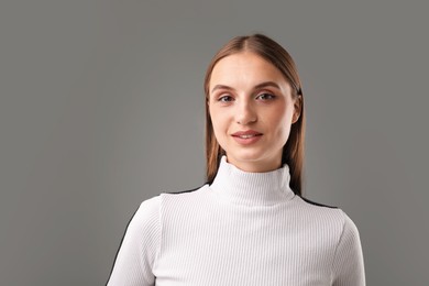 Photo of Portrait of confident woman on grey background. Space for text