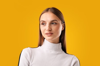 Photo of Portrait of confident woman on yellow background