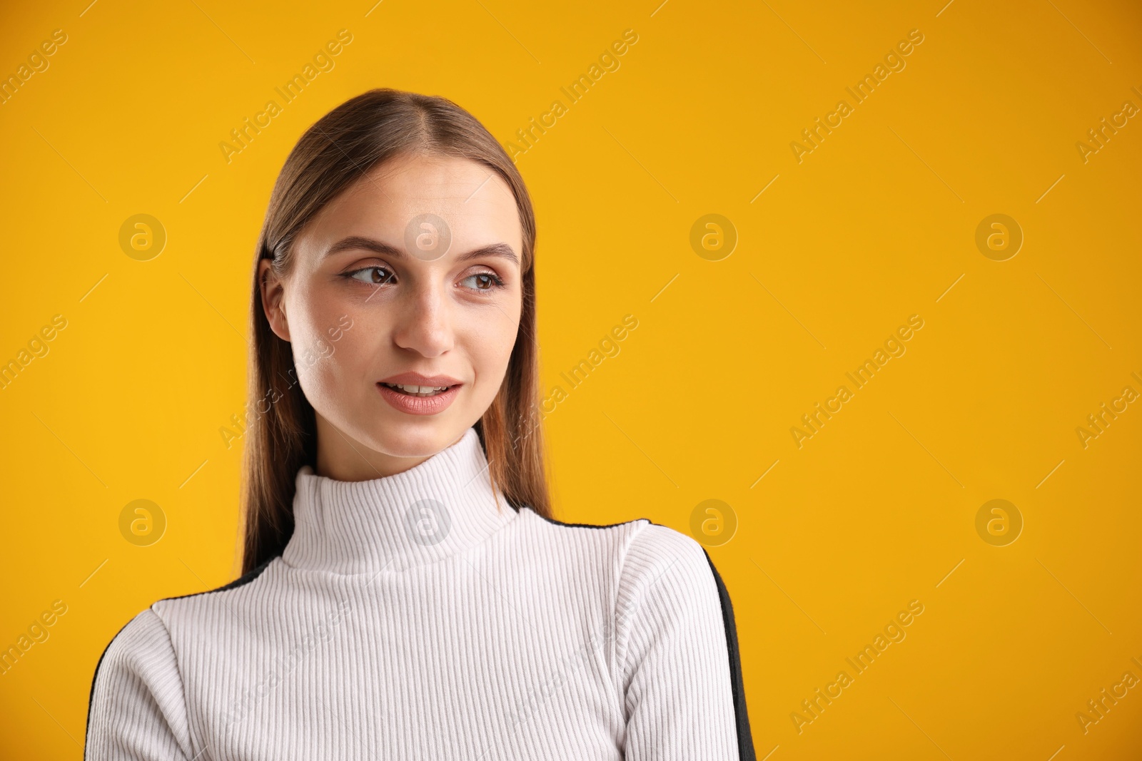 Photo of Portrait of confident woman on yellow background. Space for text