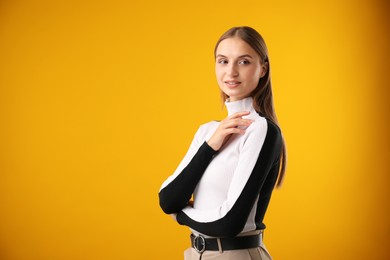 Photo of Portrait of confident woman on yellow background. Space for text