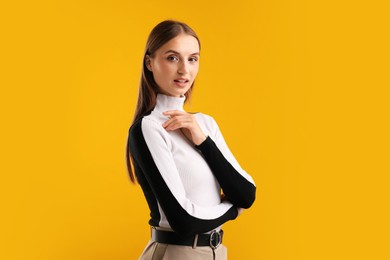 Photo of Portrait of confident woman on yellow background. Space for text
