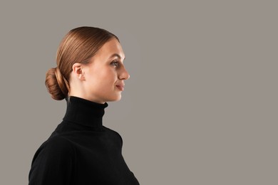 Photo of Portrait of confident woman on grey background. Space for text