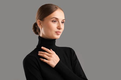 Photo of Portrait of confident woman on grey background. Space for text