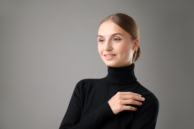 Photo of Portrait of confident woman on grey background. Space for text