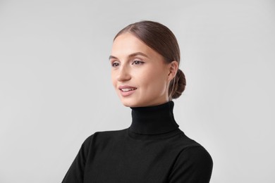 Photo of Portrait of beautiful woman on light background