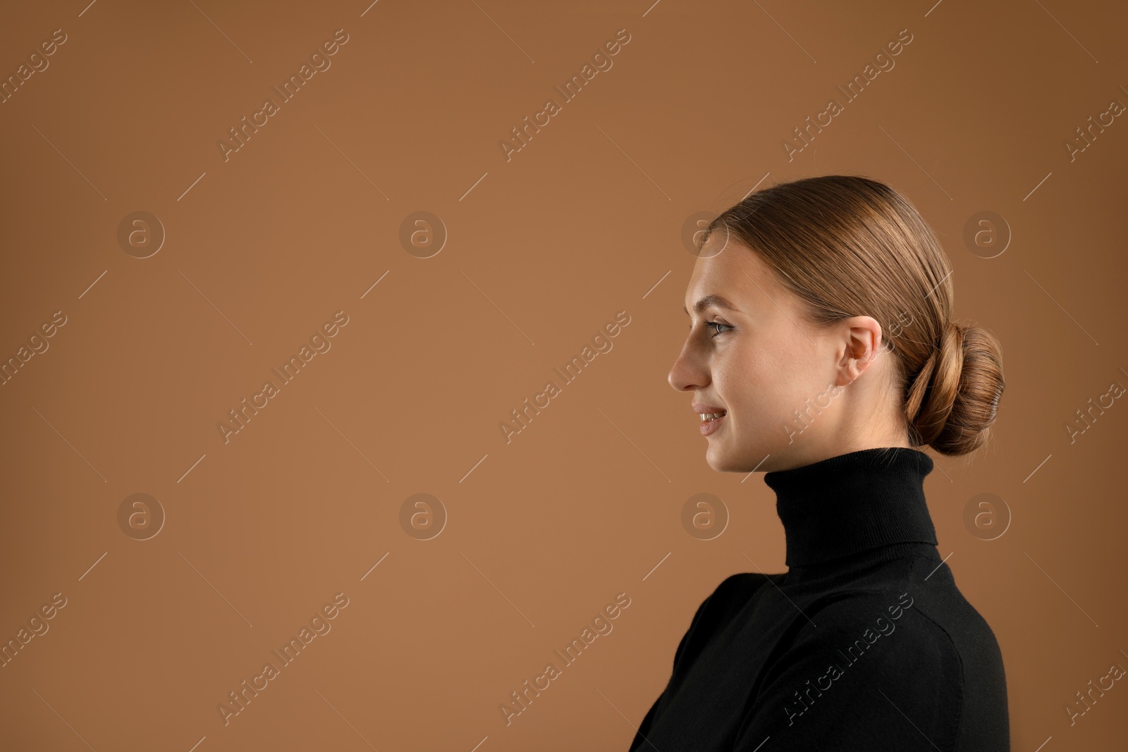 Photo of Portrait of beautiful woman on brown background. Space for text