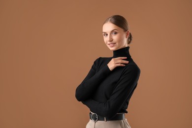 Photo of Portrait of beautiful woman on brown background. Space for text