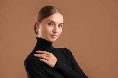 Photo of Portrait of beautiful woman on brown background. Space for text