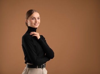 Photo of Portrait of beautiful woman on brown background. Space for text