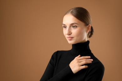 Photo of Portrait of beautiful woman on brown background. Space for text