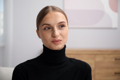 Photo of Portrait of positive elegant woman at home