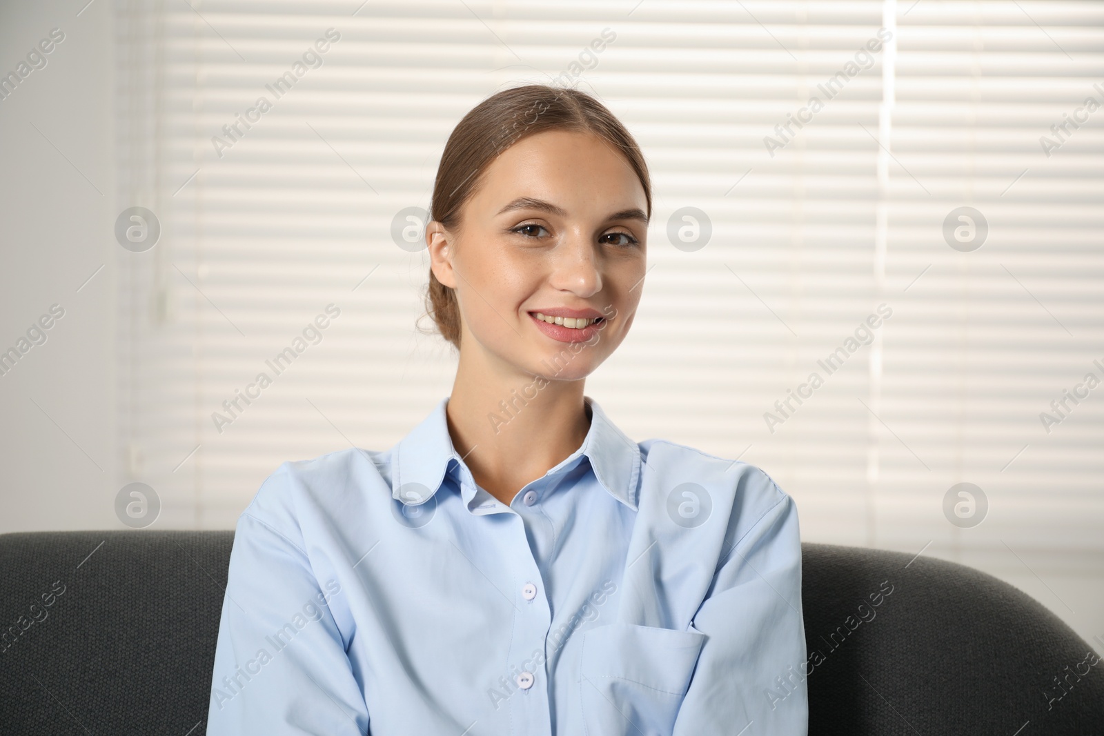 Photo of Beautiful businesswoman sitting on sofa at home