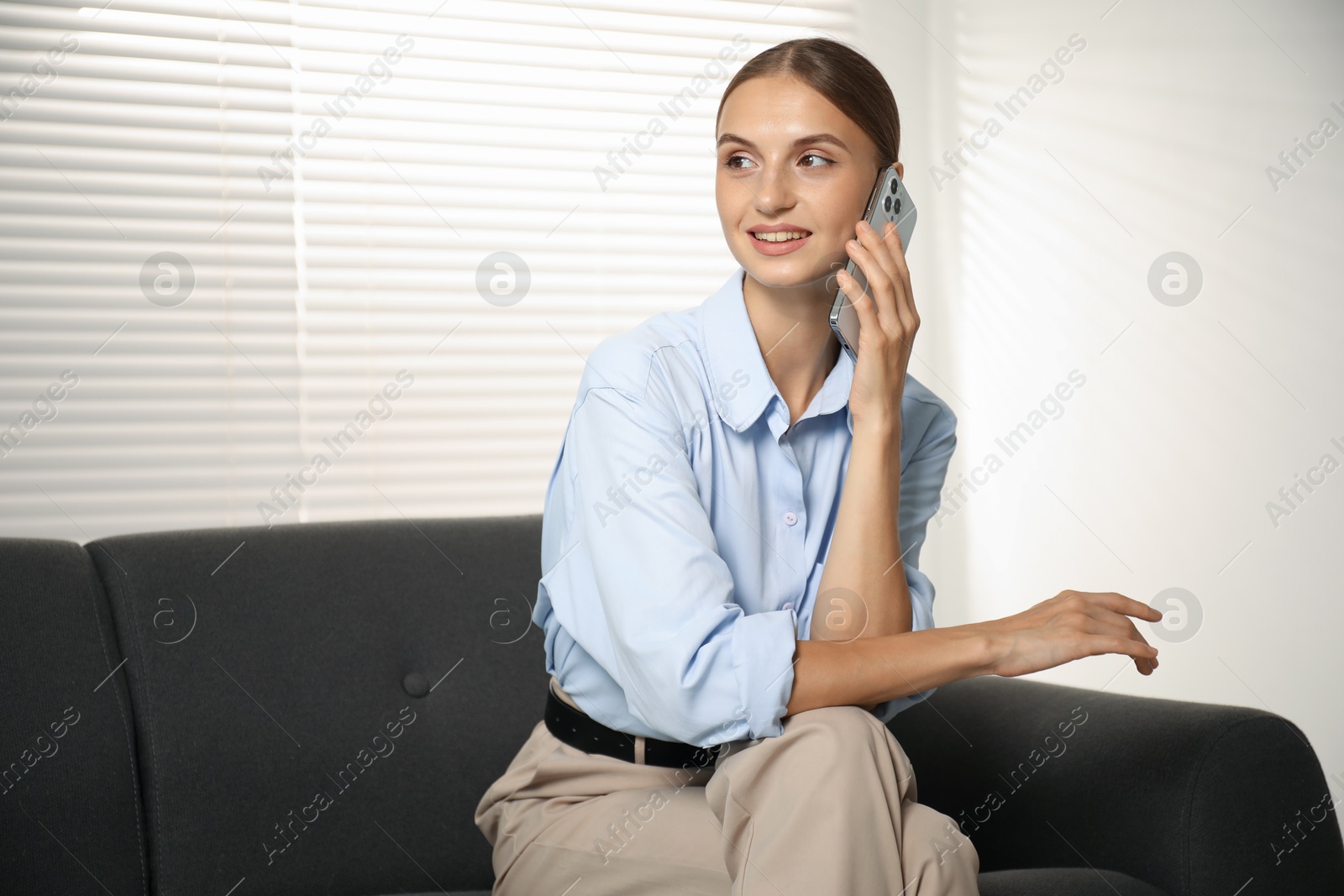 Photo of Beautiful businesswoman talking on phone at home. Space for text