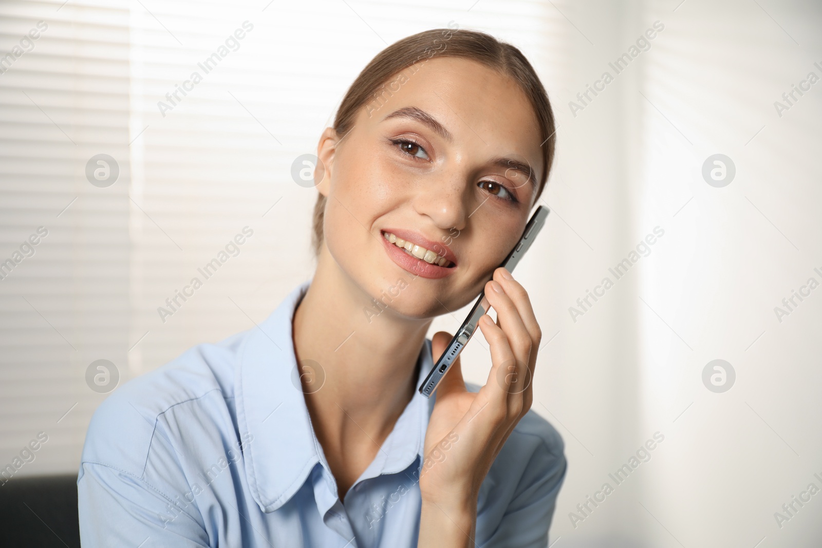 Photo of Beautiful businesswoman talking on phone at home