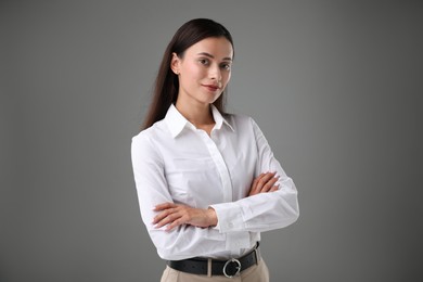Photo of Portrait of confident businesswoman on grey background