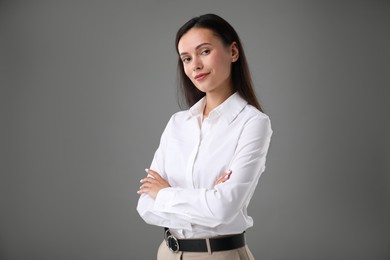 Photo of Portrait of confident businesswoman on grey background