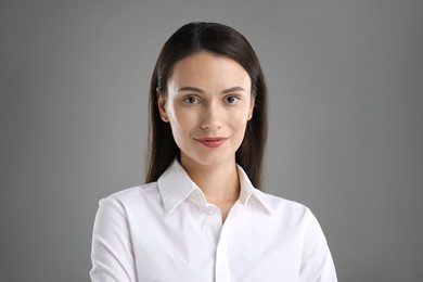 Photo of Portrait of confident businesswoman on grey background